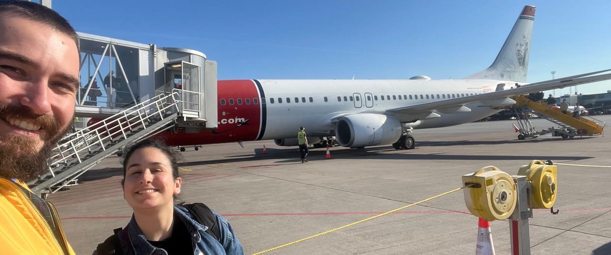 Giulia and Steve at the airport beside a plane
