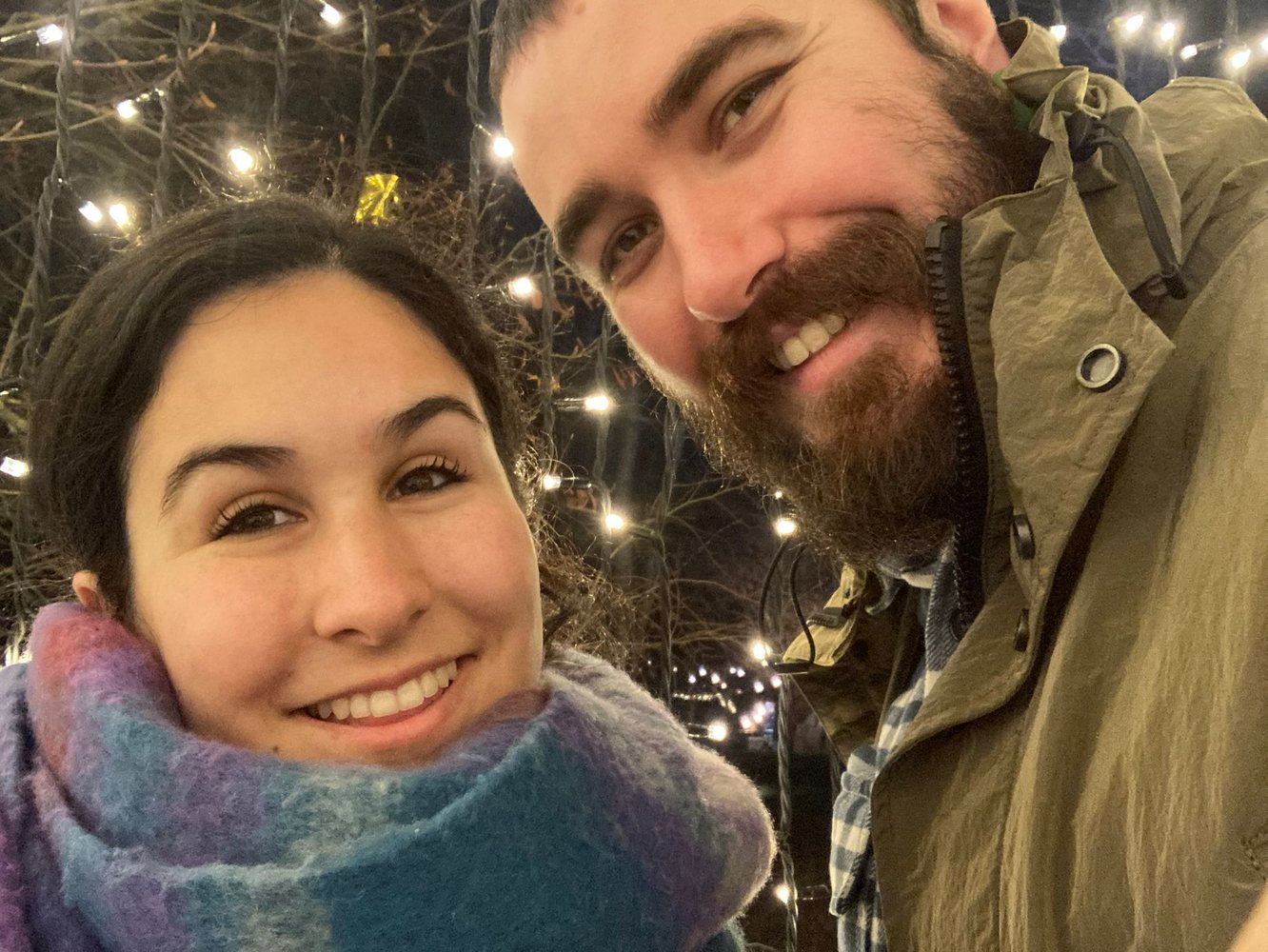 Giulia and Steve smiling under evening lights